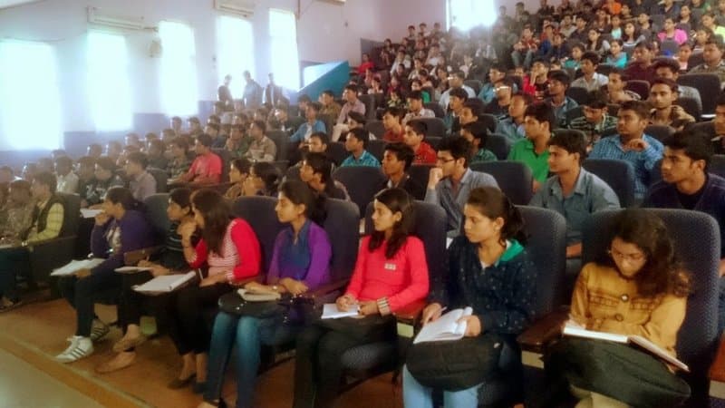 Cybersecurity workshop in progress in a college auditorium.